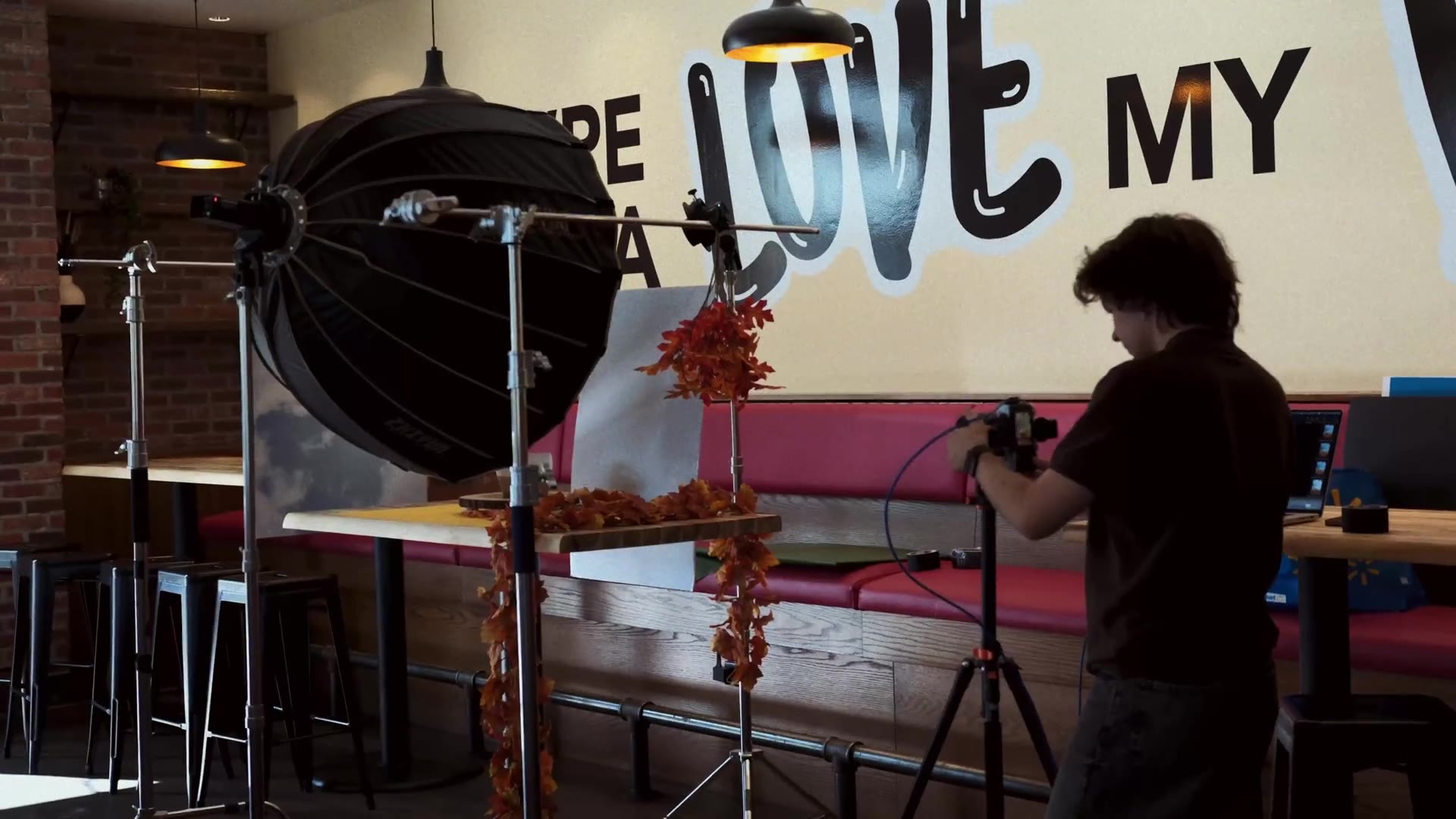 C47 camera operator filming food on location inside a restaurant